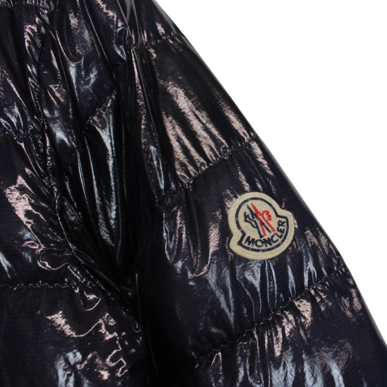 Moncler navy blue full zip down jacket with logo patch and quilted material.