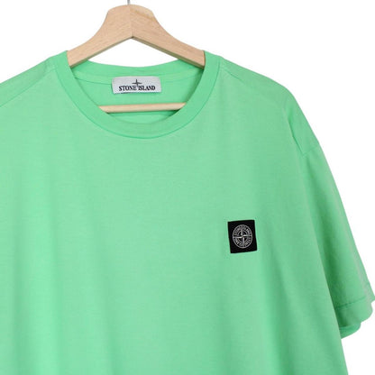 Stone Island green short sleeve cotton t-shirt with compass logo and tag detail.