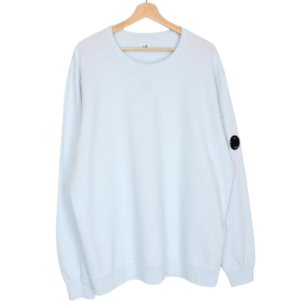CP Company light blue sweatshirt with signature lens detail and cotton fabric.