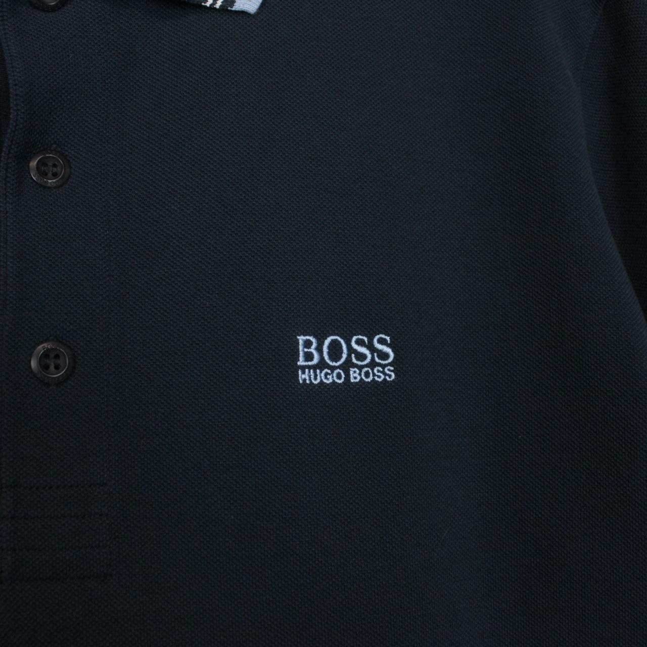 Hugo Boss navy blue short sleeve polo shirt with embroidered logo and cotton material.