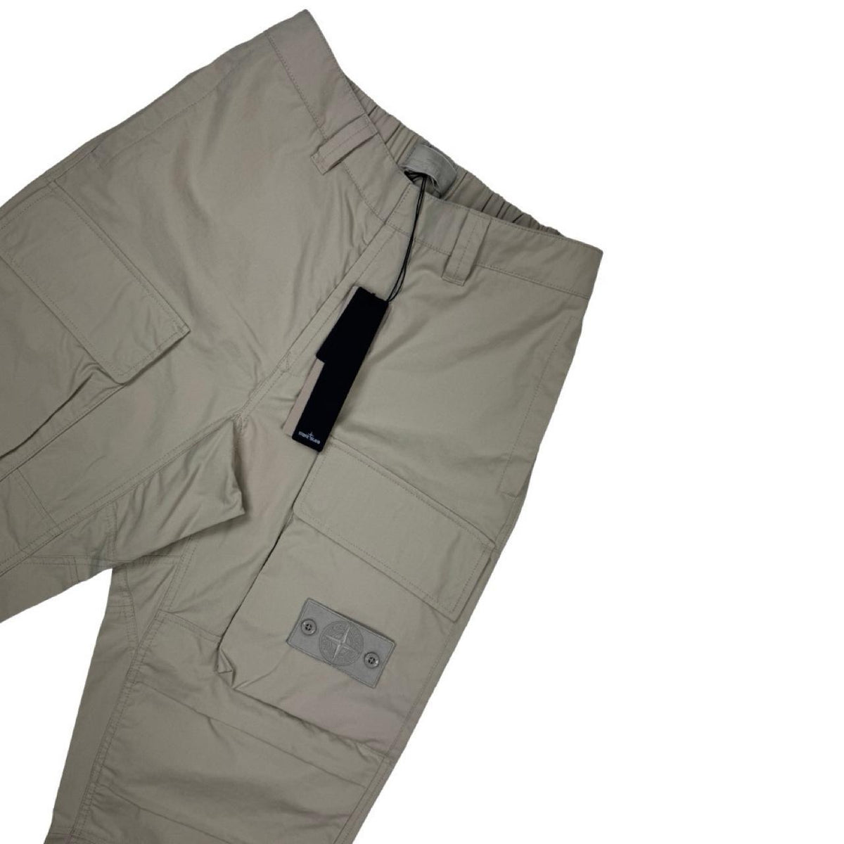 Stone Island beige cargo trousers with logo patch and multiple pockets.