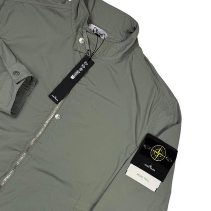 Stone Island green full zip jacket with logo patch and micro twill fabric.