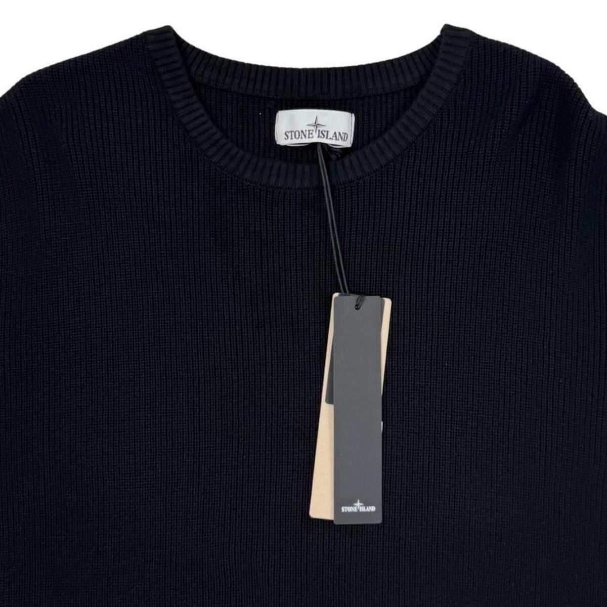 Stone Island black ribbed knit jumper with logo badge and organic cotton material.