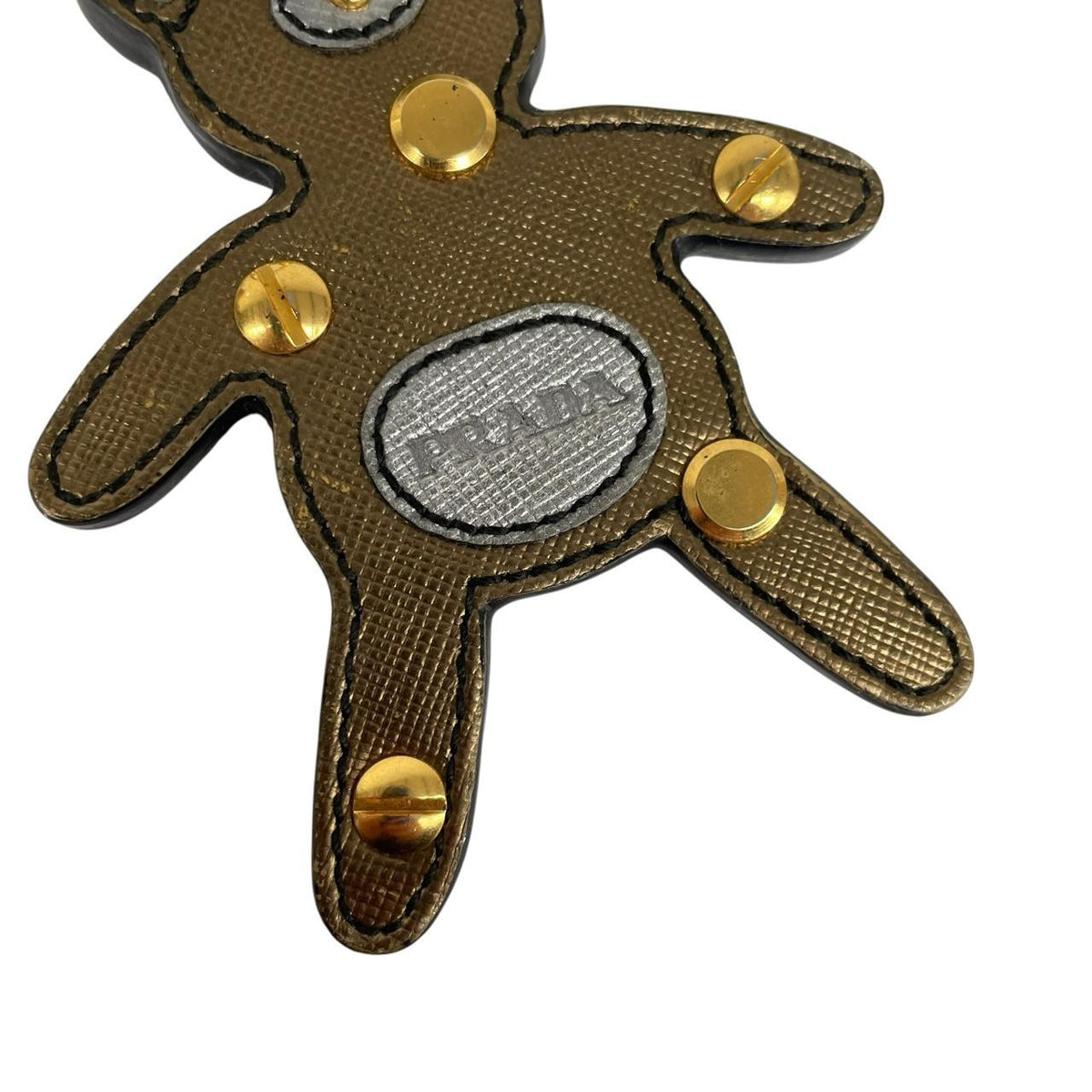 Prada brown and gold teddy bear bag charm in Saffiano leather with logo detail.
