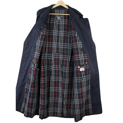 Burberry navy blue belted double breasted trench coat with classic check lining.