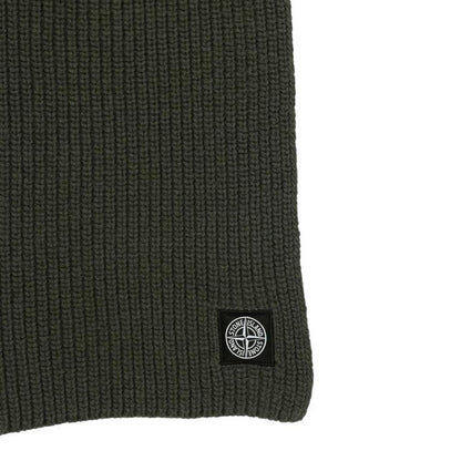 Stone Island green wool scarf with ribbed texture and embroidered logo patch.