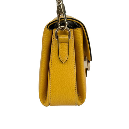 Gucci yellow leather crossbody bag with interlocking G logo and minor metal scratches.