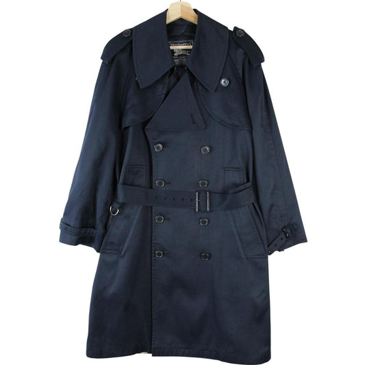 Burberry navy blue double breasted trench coat with belted waist and classic check lining.