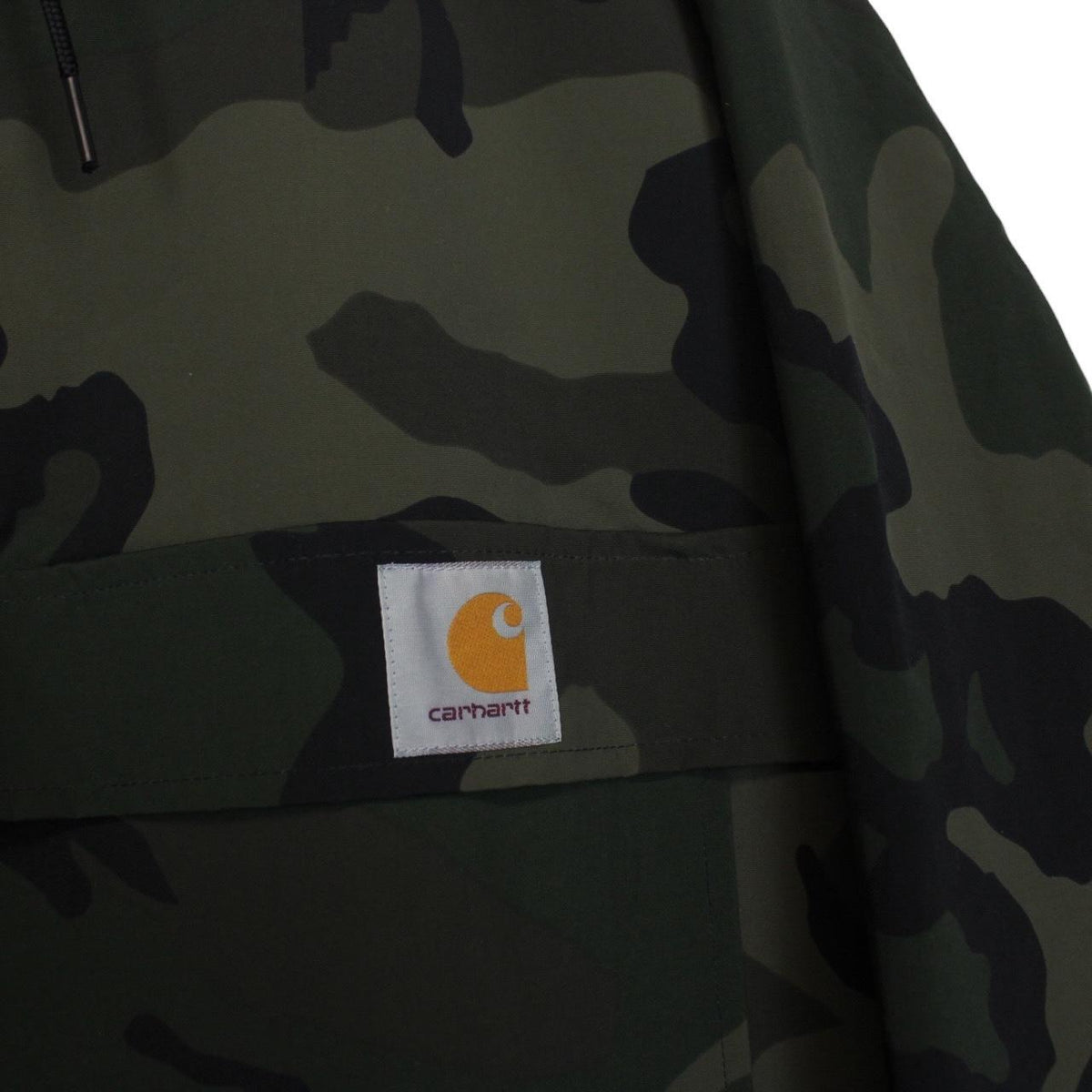 Carhartt camouflage hooded pullover jacket with logo and durable material.