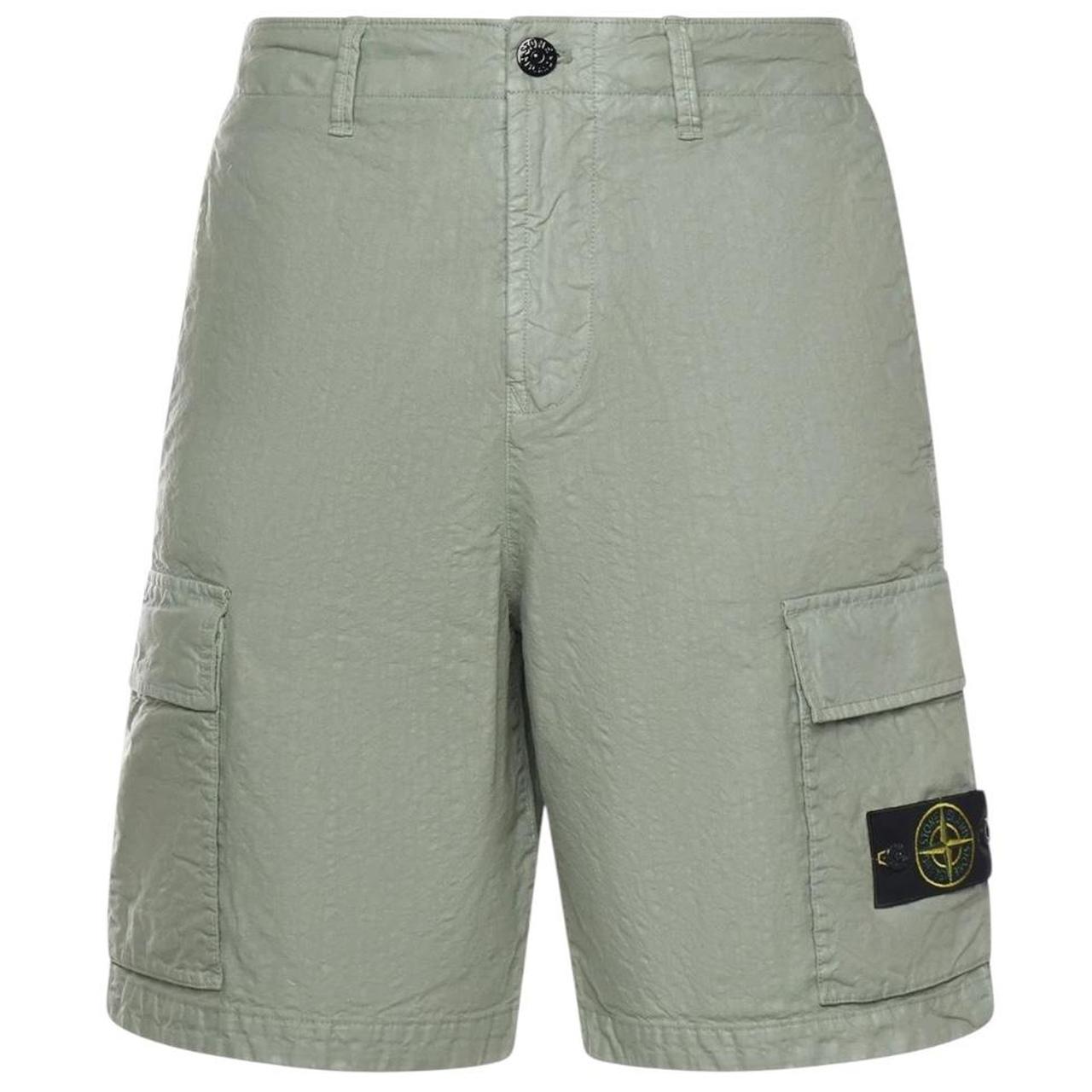 Stone Island green cargo shorts with multiple pockets and "OLD" effect garment-dye treatment.