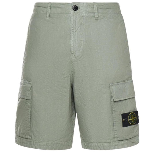 Stone Island green cargo shorts with multiple pockets and "OLD" effect garment-dye treatment.