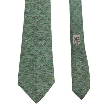 Hermes green silk tie featuring zebra print design and logo detail.