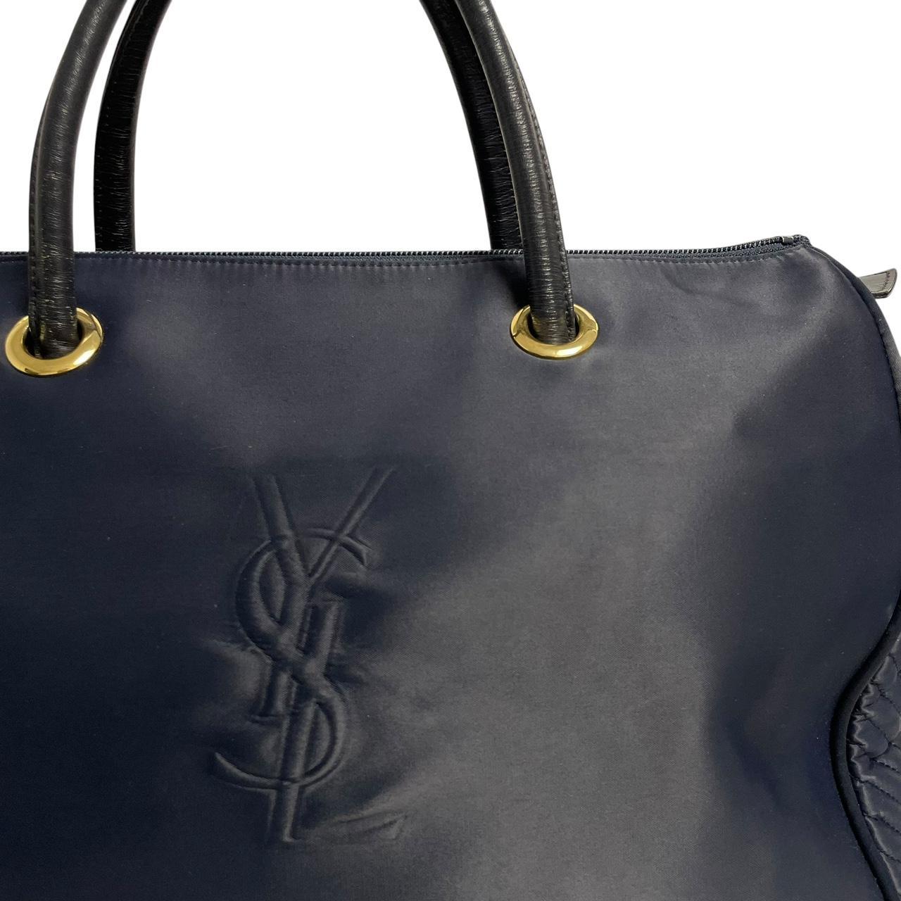 Yves Saint Laurent navy blue duffel bag embossed logo nylon material with handles.