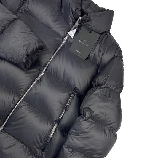 Moncler black nylon down puffer jacket with logo patch and quilted design.