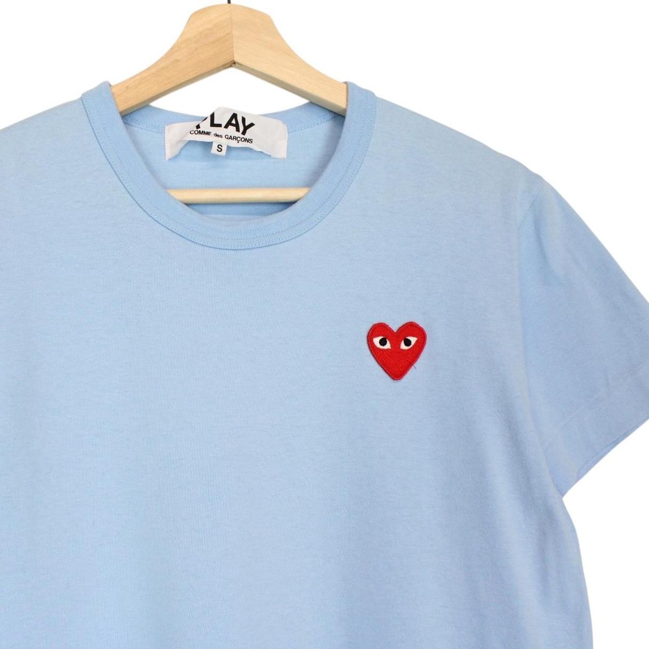 Comme des Garcons light blue short sleeve cotton t-shirt with heart logo and pocket.