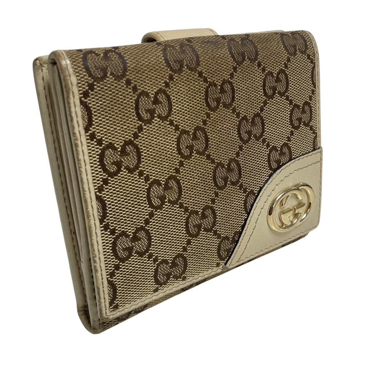 Gucci brown bifold wallet with Supreme monogram pattern and leather accents.