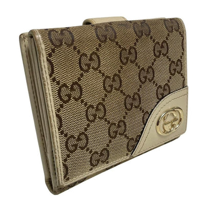Gucci brown bifold wallet with Supreme monogram pattern and leather accents.