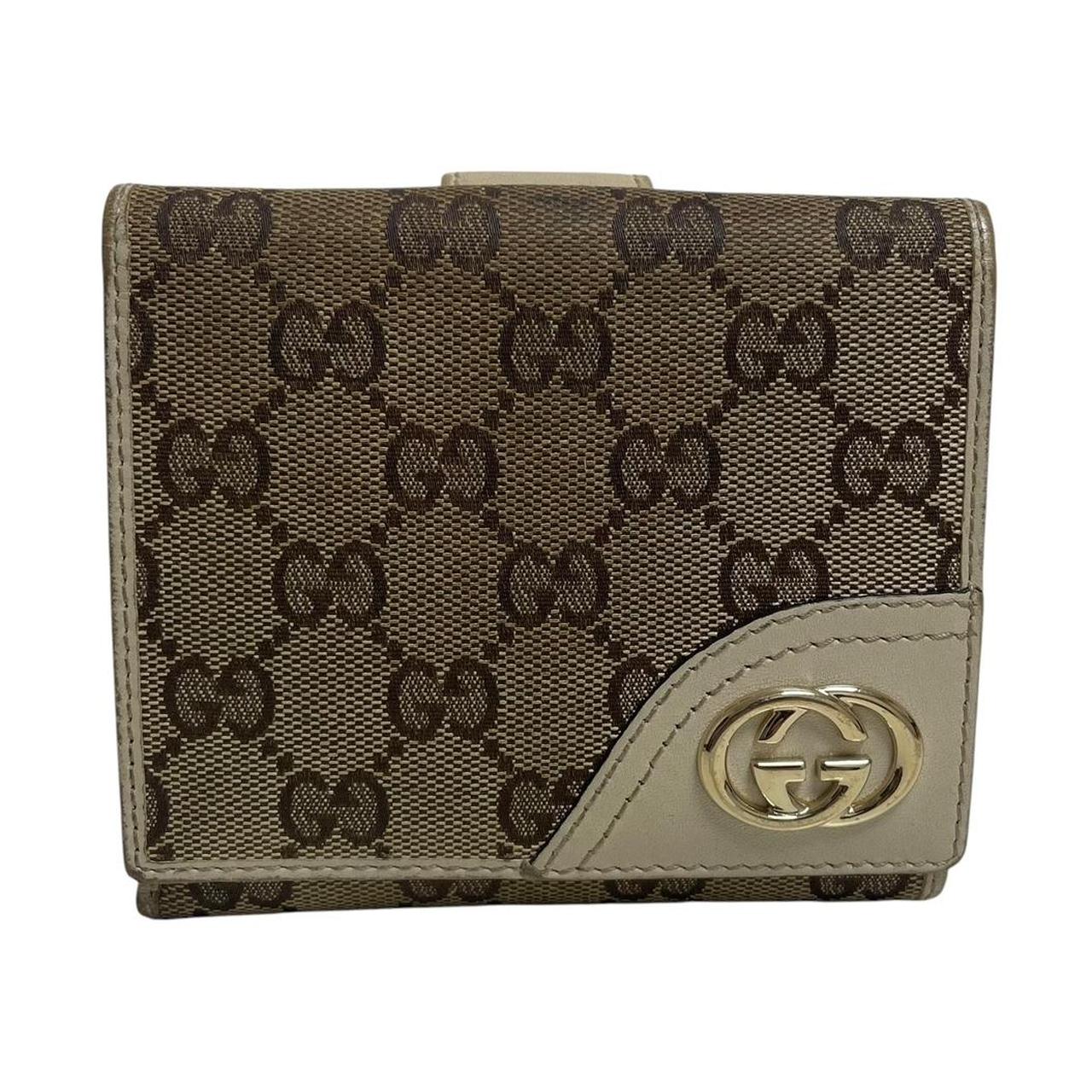 Gucci brown bifold wallet with Supreme monogram pattern and leather accents.