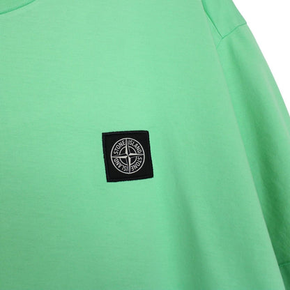 Stone Island green short sleeve cotton t-shirt with compass logo and tag detail.