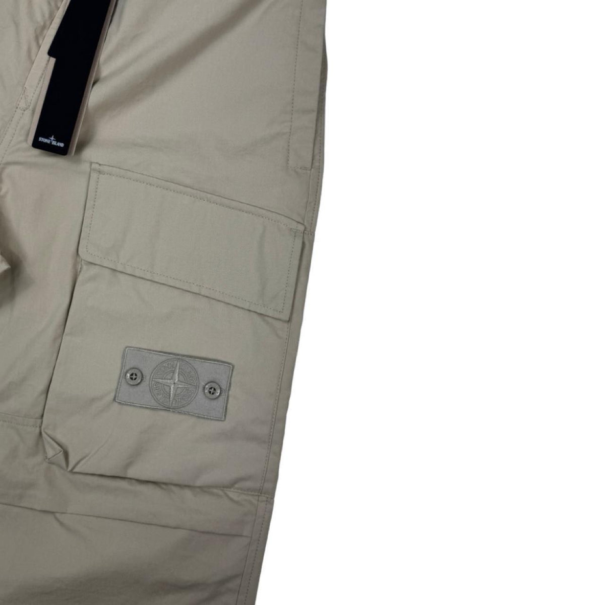 Stone Island beige cargo trousers with logo patch and multiple pockets.