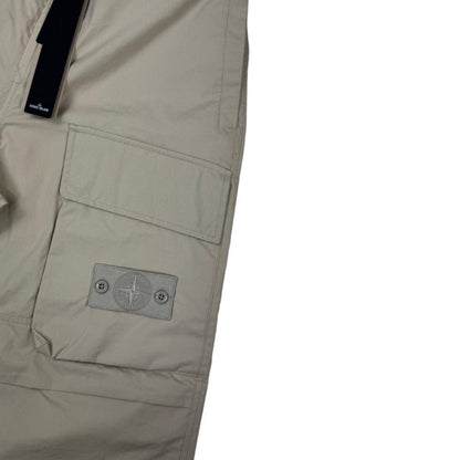 Stone Island beige cargo trousers with logo patch and multiple pockets.