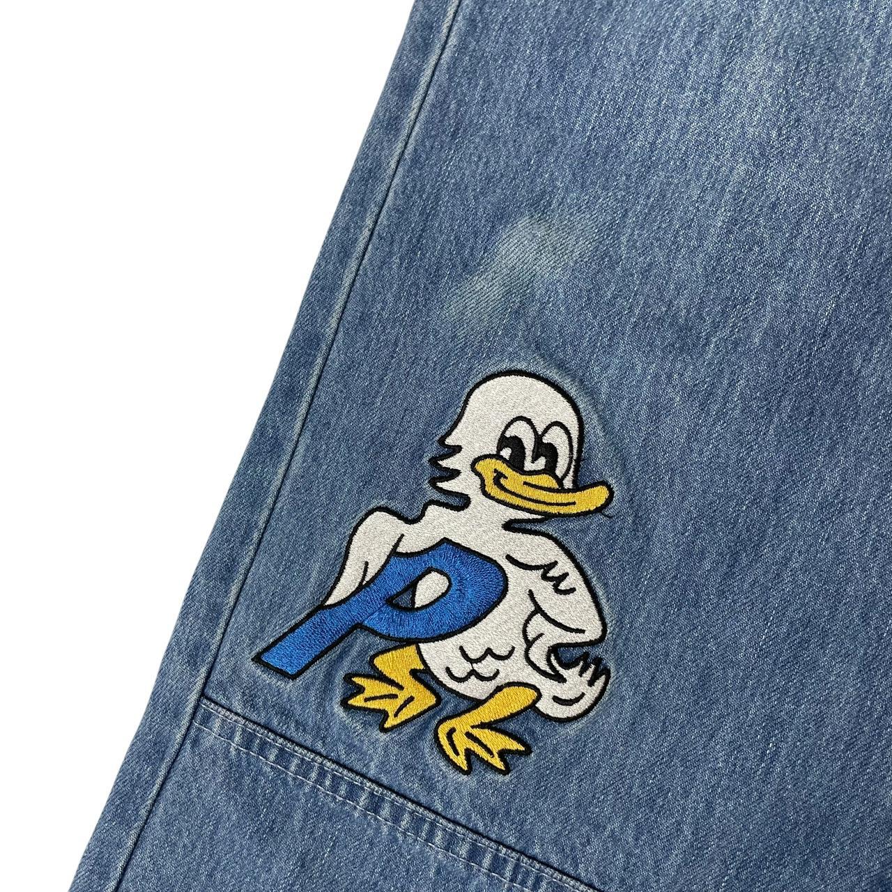 Palace blue straight jeans with mid stone wash and quacked pattern details.
