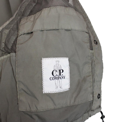 CP Company khaki green and grey jacket with shibori pattern and lens detail.