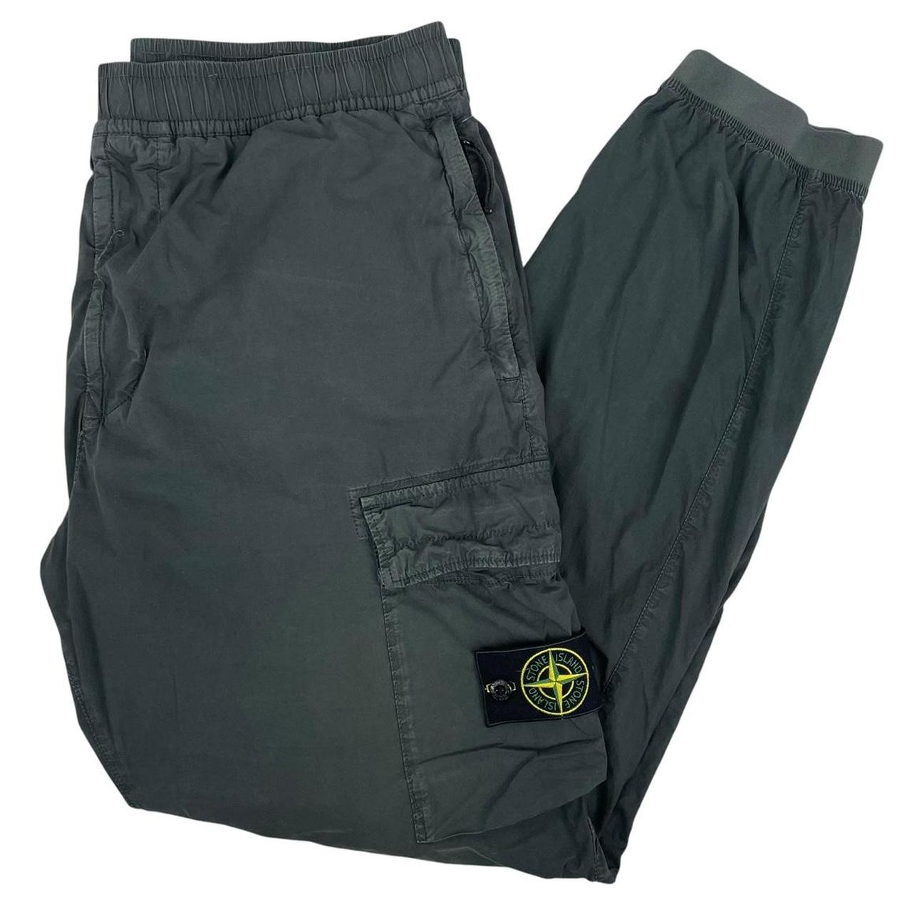 Stone Island grey cargo trousers with logo patch and loose stitch detail.