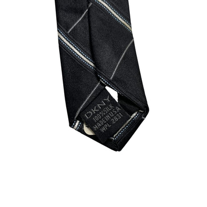 DKNY black silk tie with vintage striped pattern and logo detail.