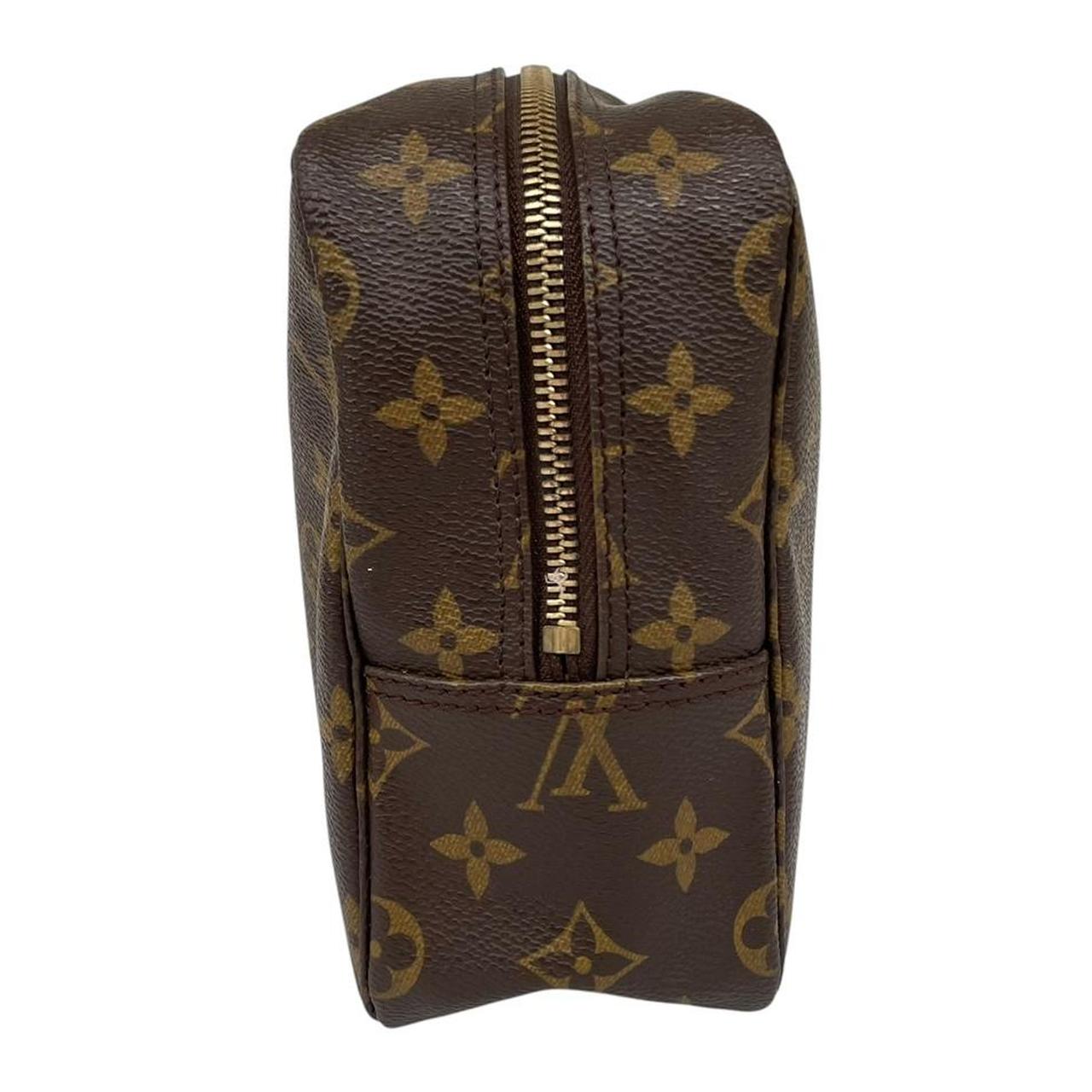 Louis Vuitton brown and tan monogram toiletry pouch with iconic logo and canvas material.