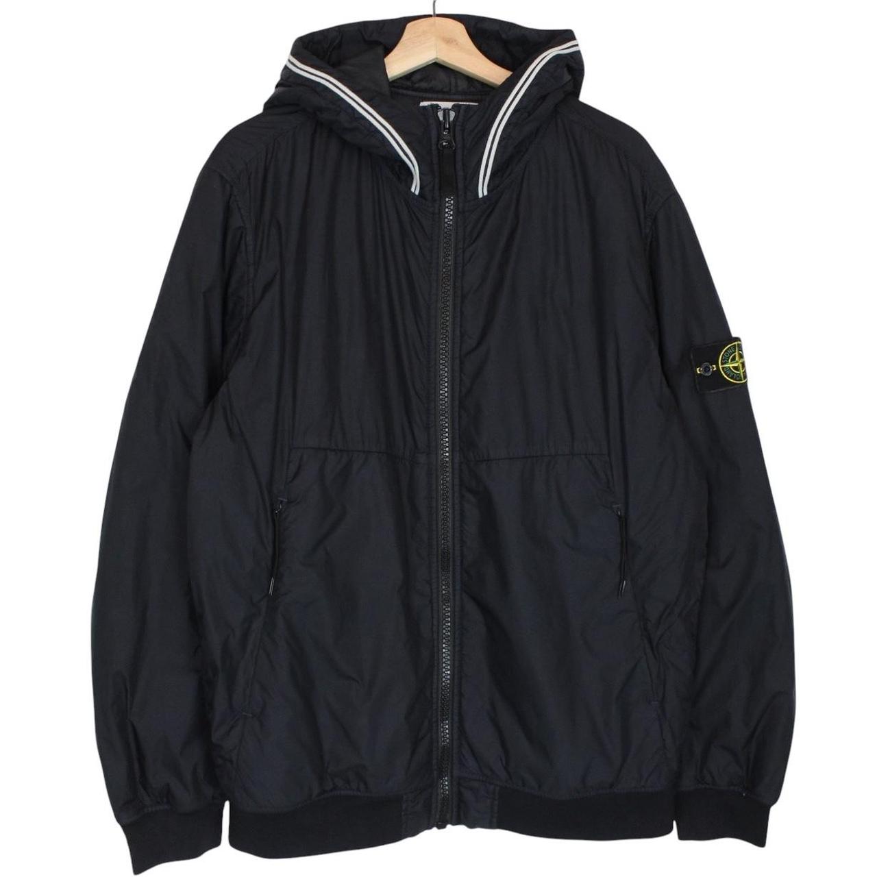 Stone Island black jacket with crinkle texture and logo patch on sleeve.