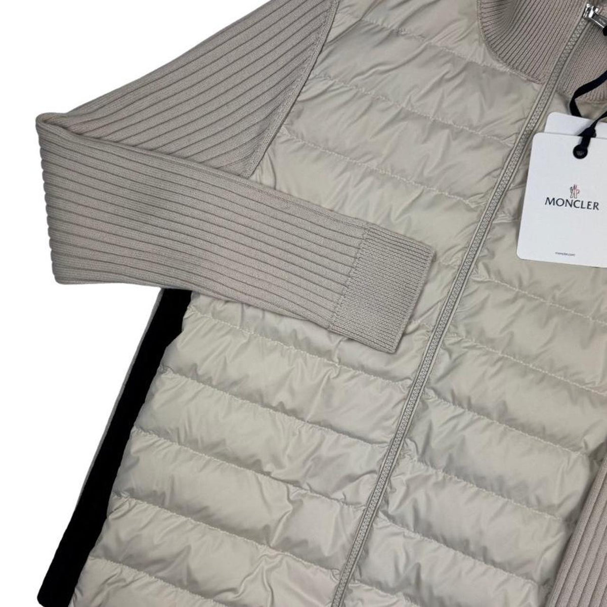 Moncler beige full zip jacket with logo detail and nylon/wool blend material.