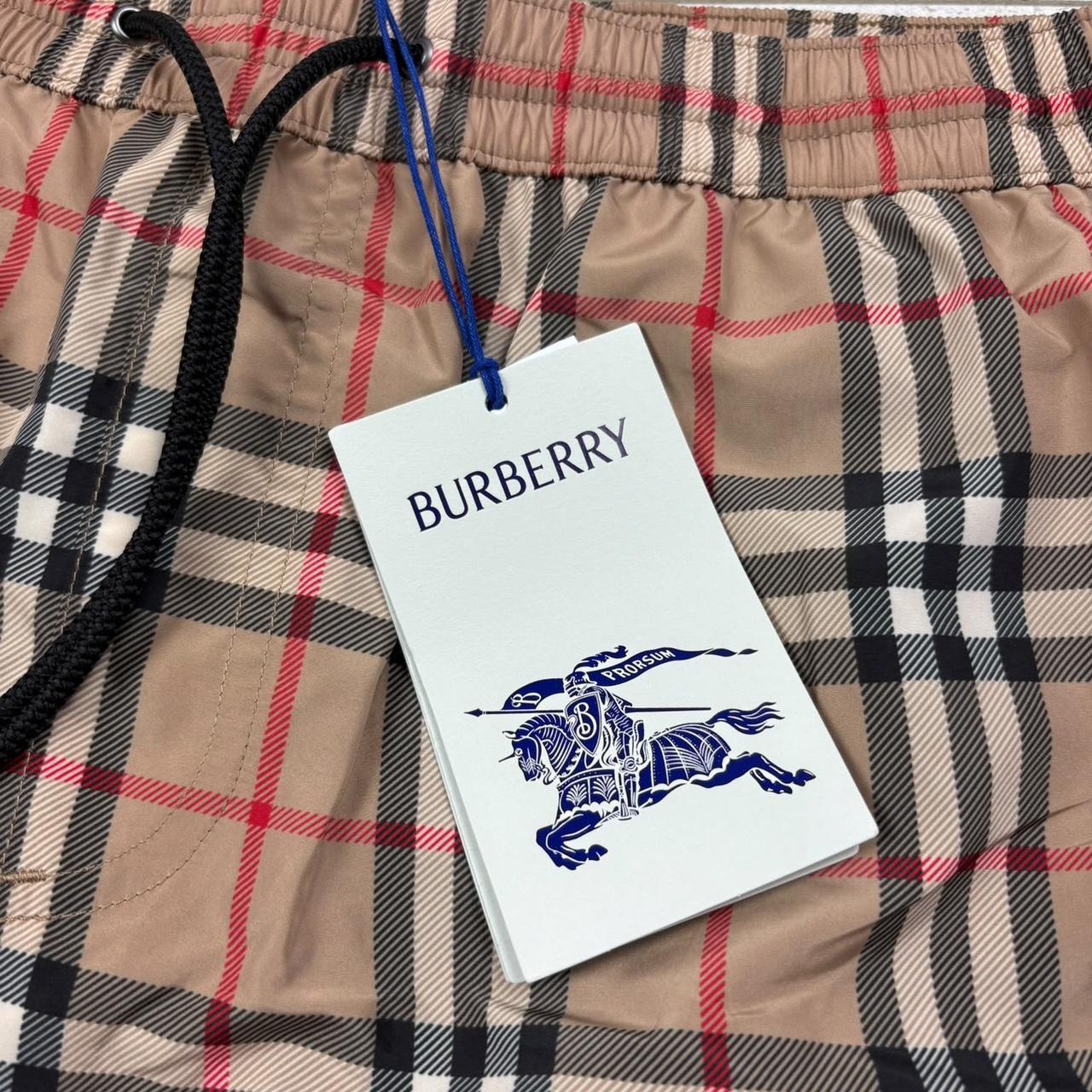 Burberry beige swim shorts featuring Nova Check pattern and nylon material.