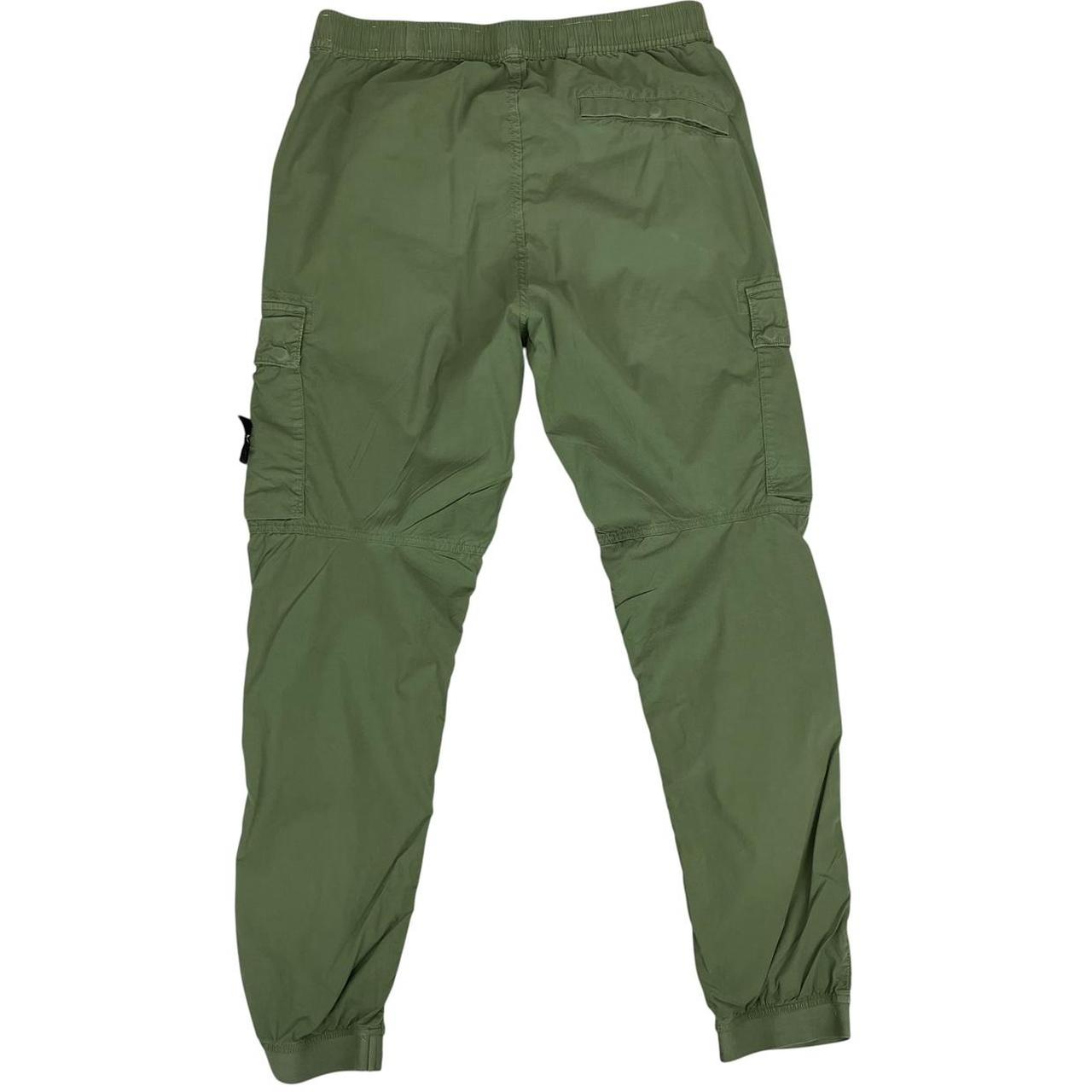 Stone Island green cargo trousers with logo patch and multiple pockets.