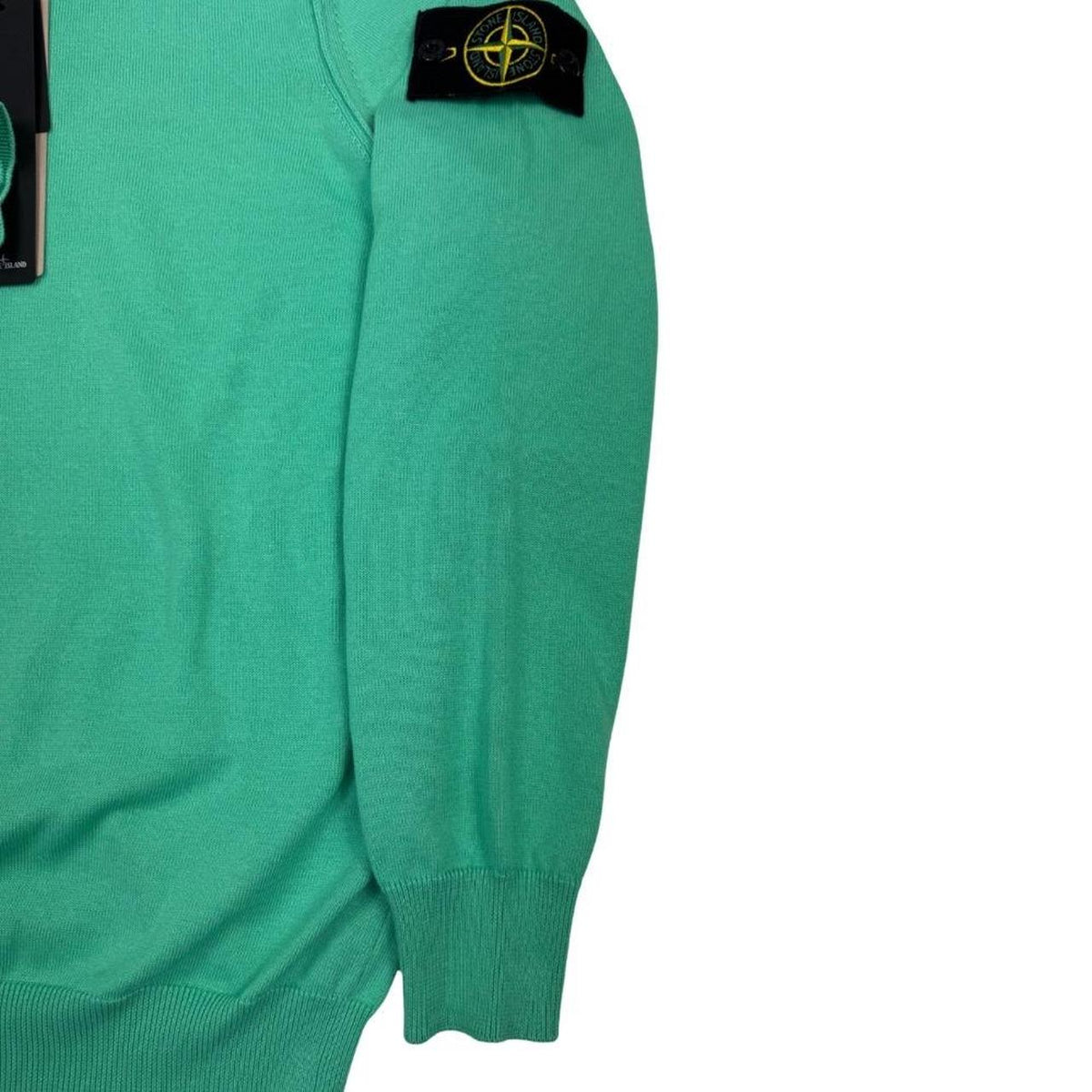 Stone Island green knit jumper made from organic cotton with logo patch detail.