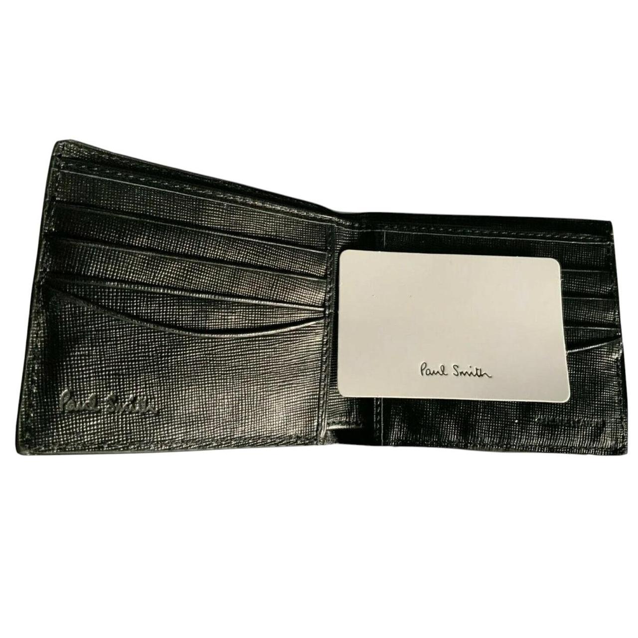 Paul Smith black bifold wallet textured crosshatch leather with logo detail.