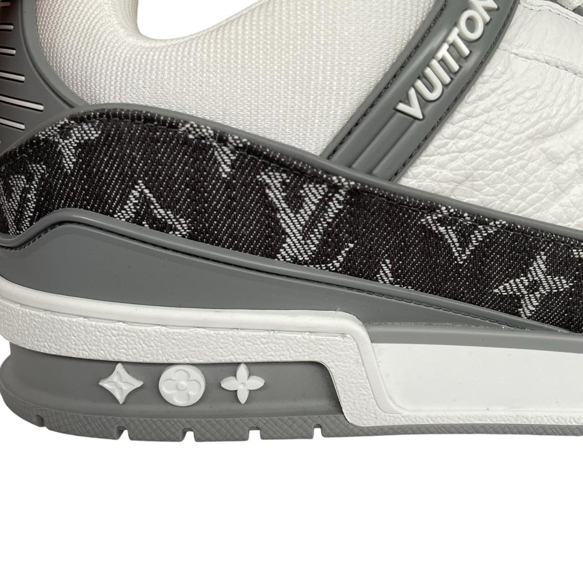 Louis Vuitton grey and white trainers with monogram pattern and leather accents.