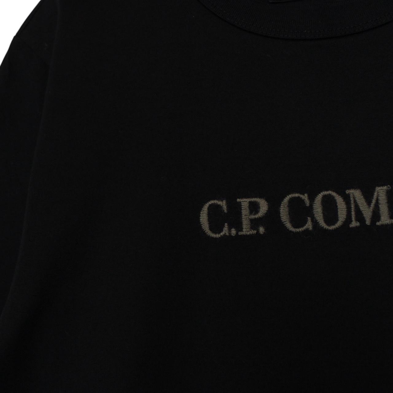 CP Company black pocket t-shirt with embroidered logo and mercerized cotton material.