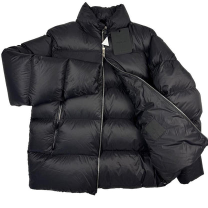 Moncler black nylon down puffer jacket with logo patch and quilted design.