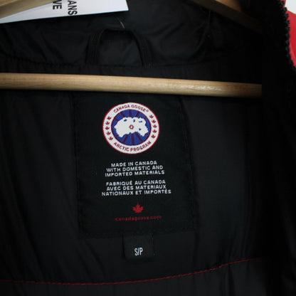 Canada Goose red down gilet with logo patch and zippered pockets.