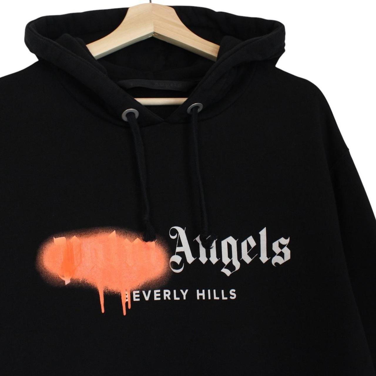 Palm Angels black and orange hoodie with Beverly Hills spray design and cotton material.
