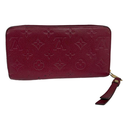 Louis Vuitton black leather wallet with monogram pattern and embossed logo.