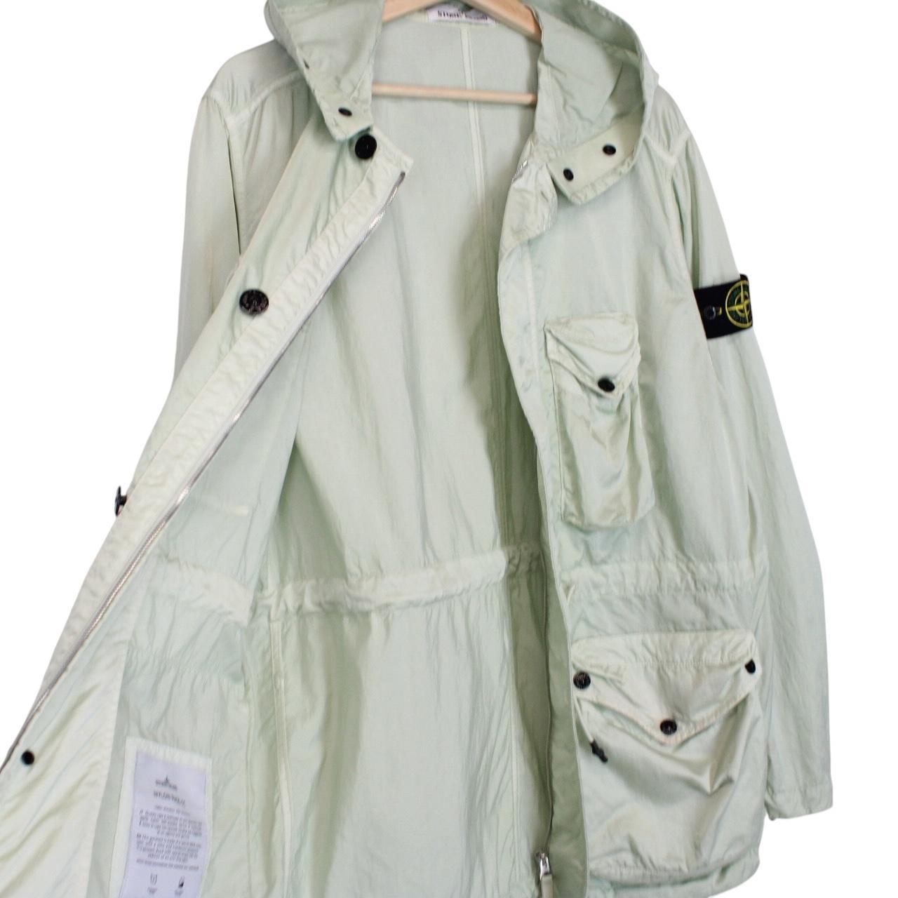 Stone Island mint green multi pocket jacket with logo patch and nylon material.