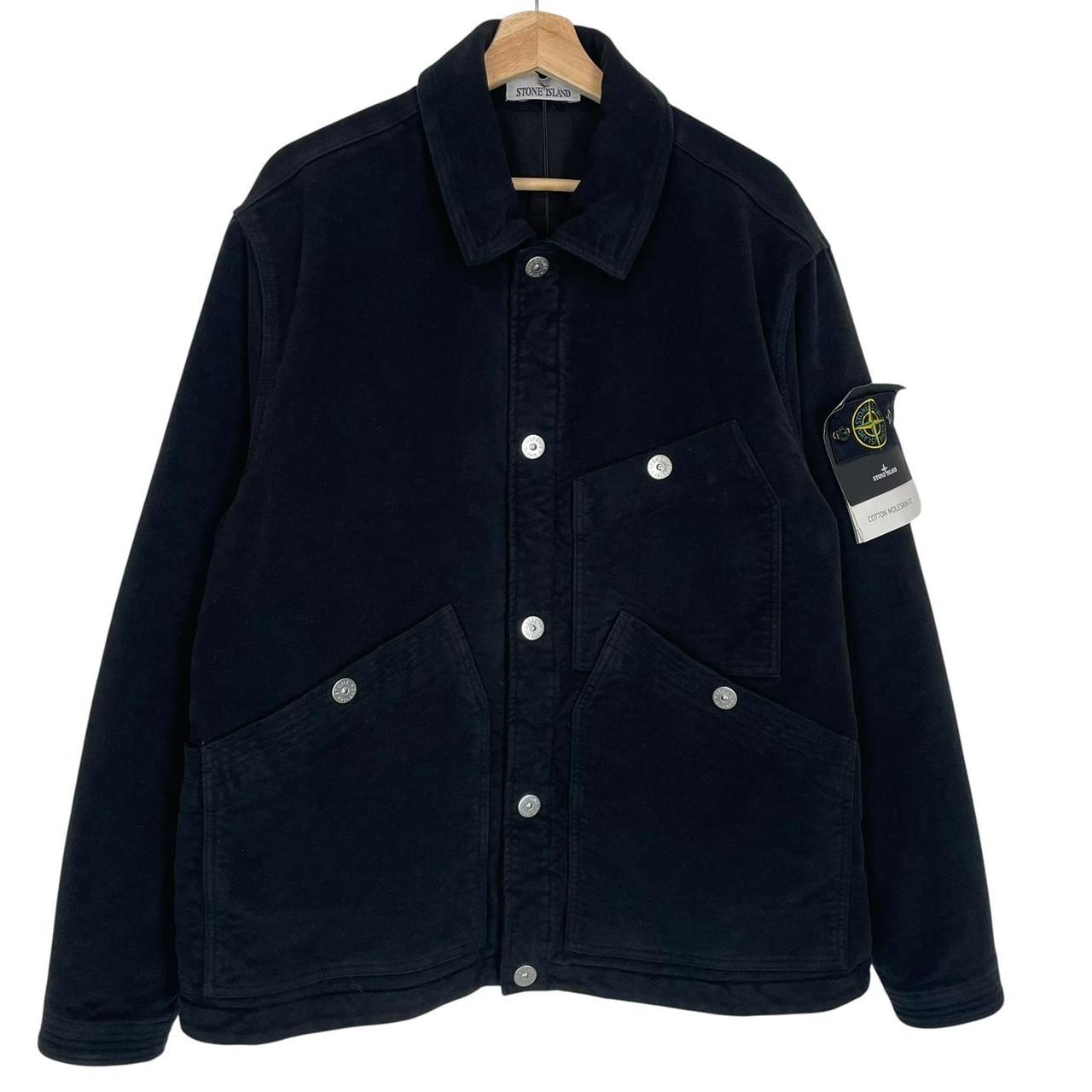 Stone Island navy blue work jacket with detachable compass badge and button-down closure.
