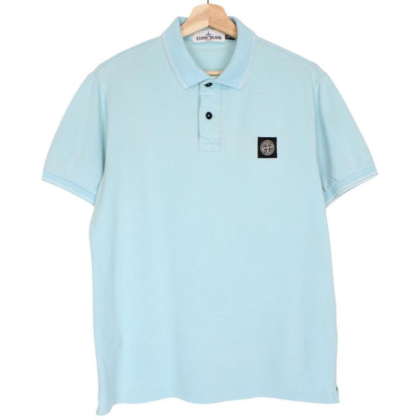 Stone Island blue polo shirt with embroidered compass logo and slim fit cotton material.