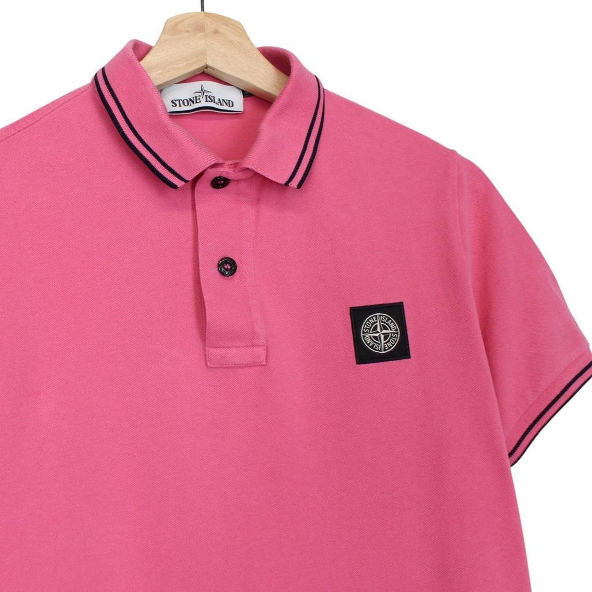 Stone Island pink short sleeve polo shirt with embroidered compass logo, cotton material.
