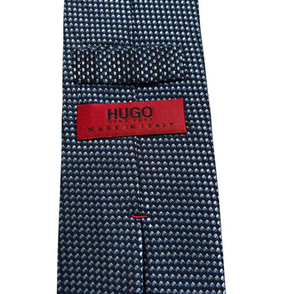 Hugo Boss blue silk tie with white polka dots and logo detail.