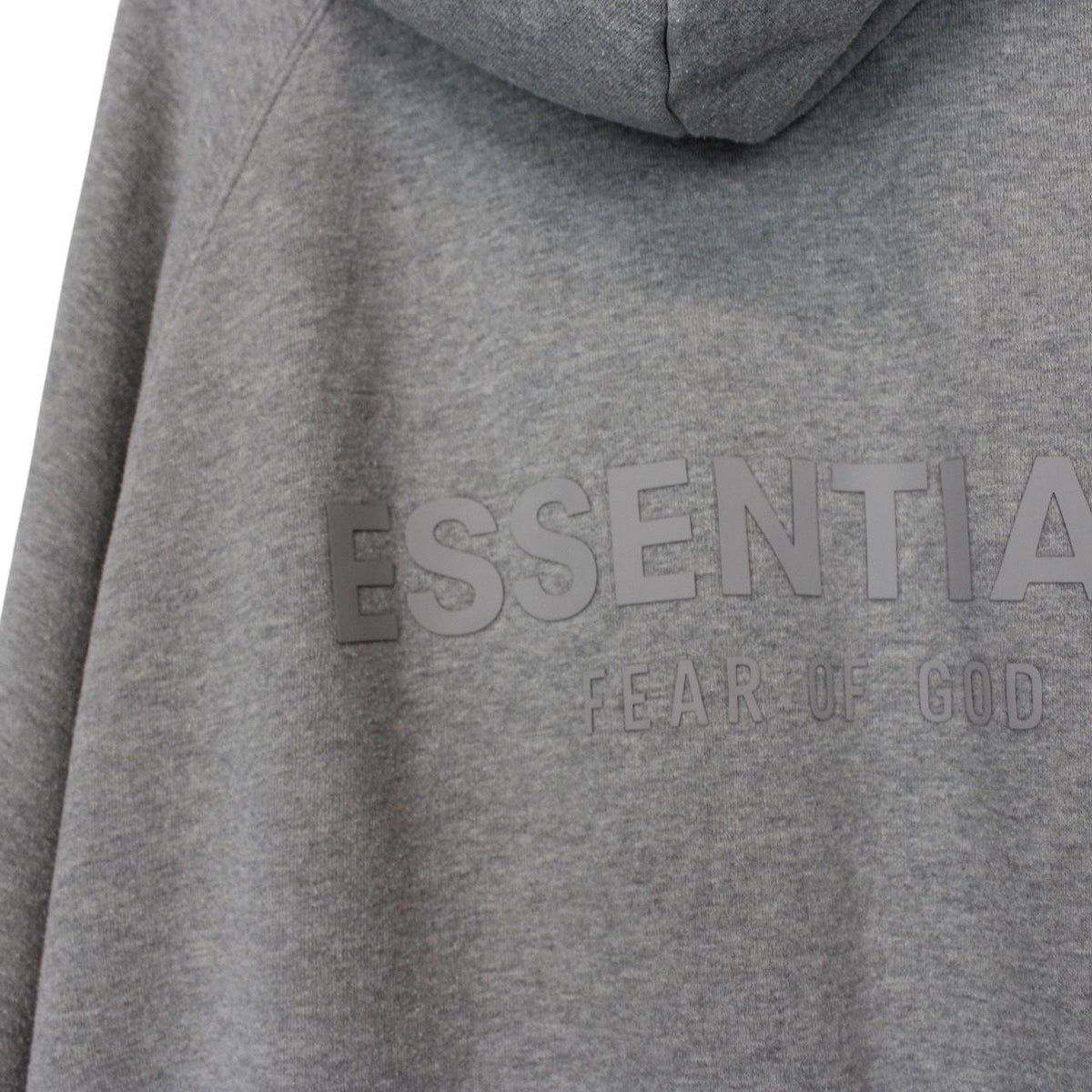 Essentials grey hoodie jumper with oversized fit and subtle logo detail.