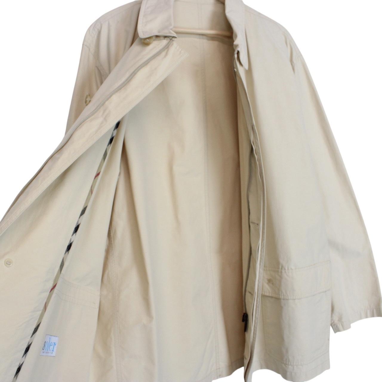 Burberry beige coat with classic check pattern and logo detail on collar.