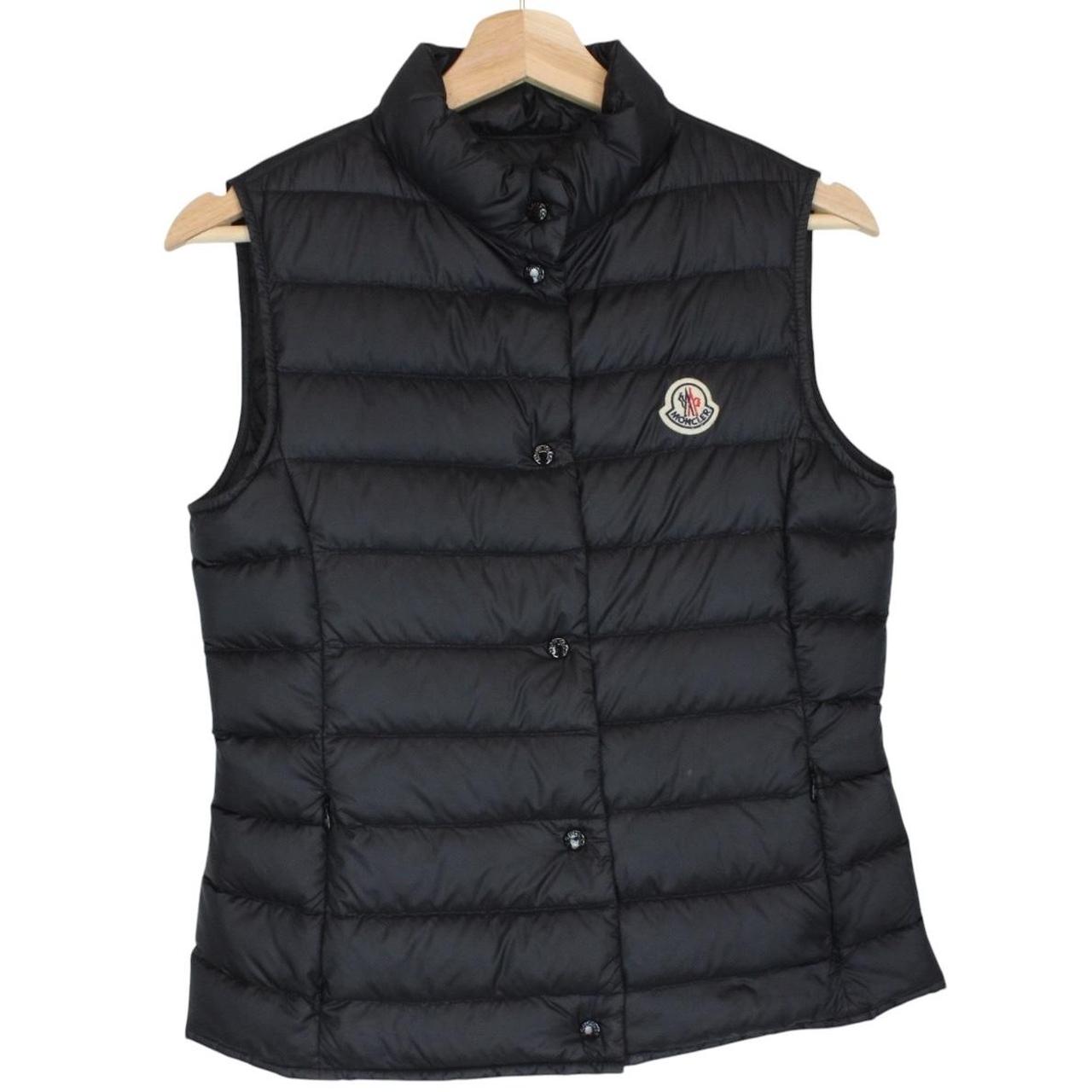 Moncler black quilted shell down gilet with logo patch and zip pockets.
